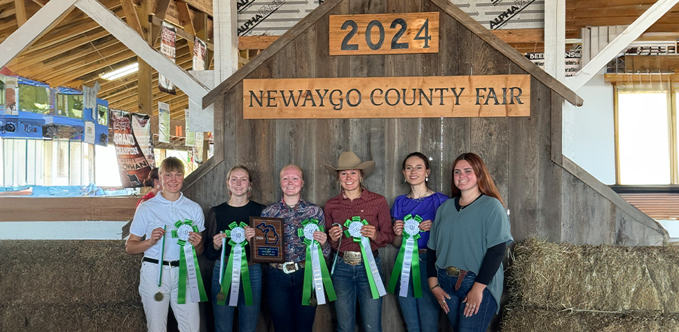 Group of six people posing with awards at the Newaygo County Fair.